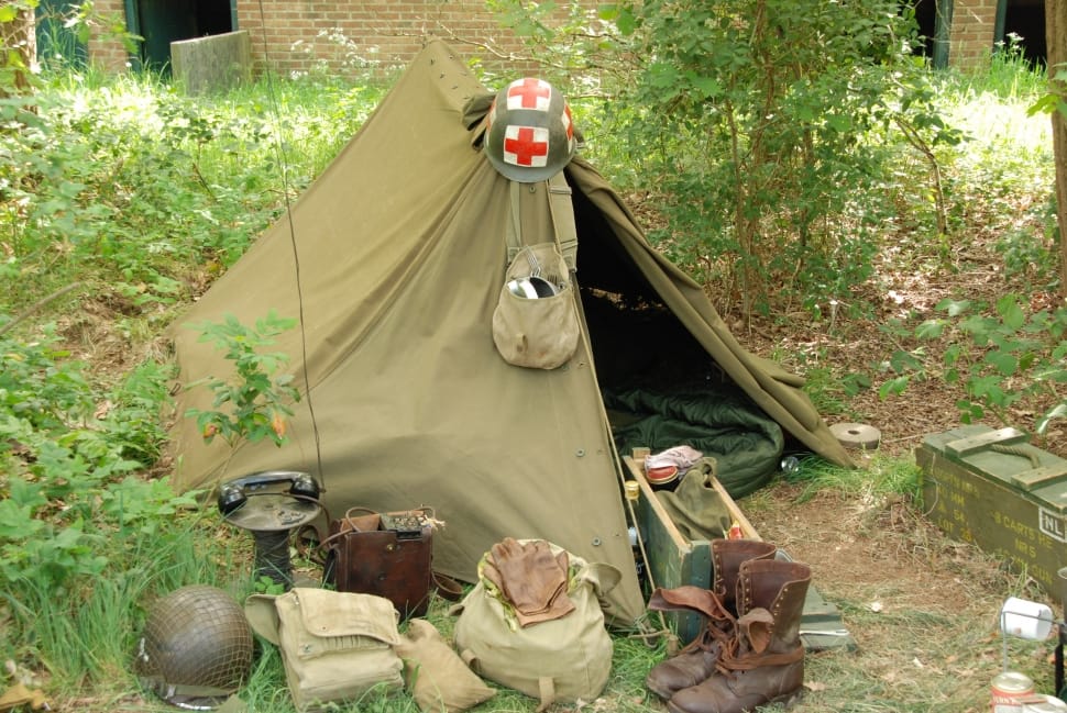 green fabric tent and army helmet preview