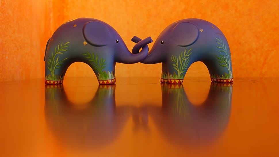 2 purple and green elephant figurines preview