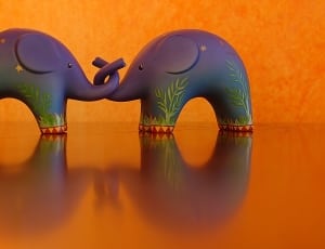 2 purple and green elephant figurines thumbnail