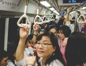 people standing and sitting in train thumbnail