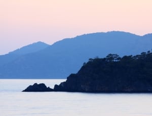 silhouette of mountain range and ocean thumbnail