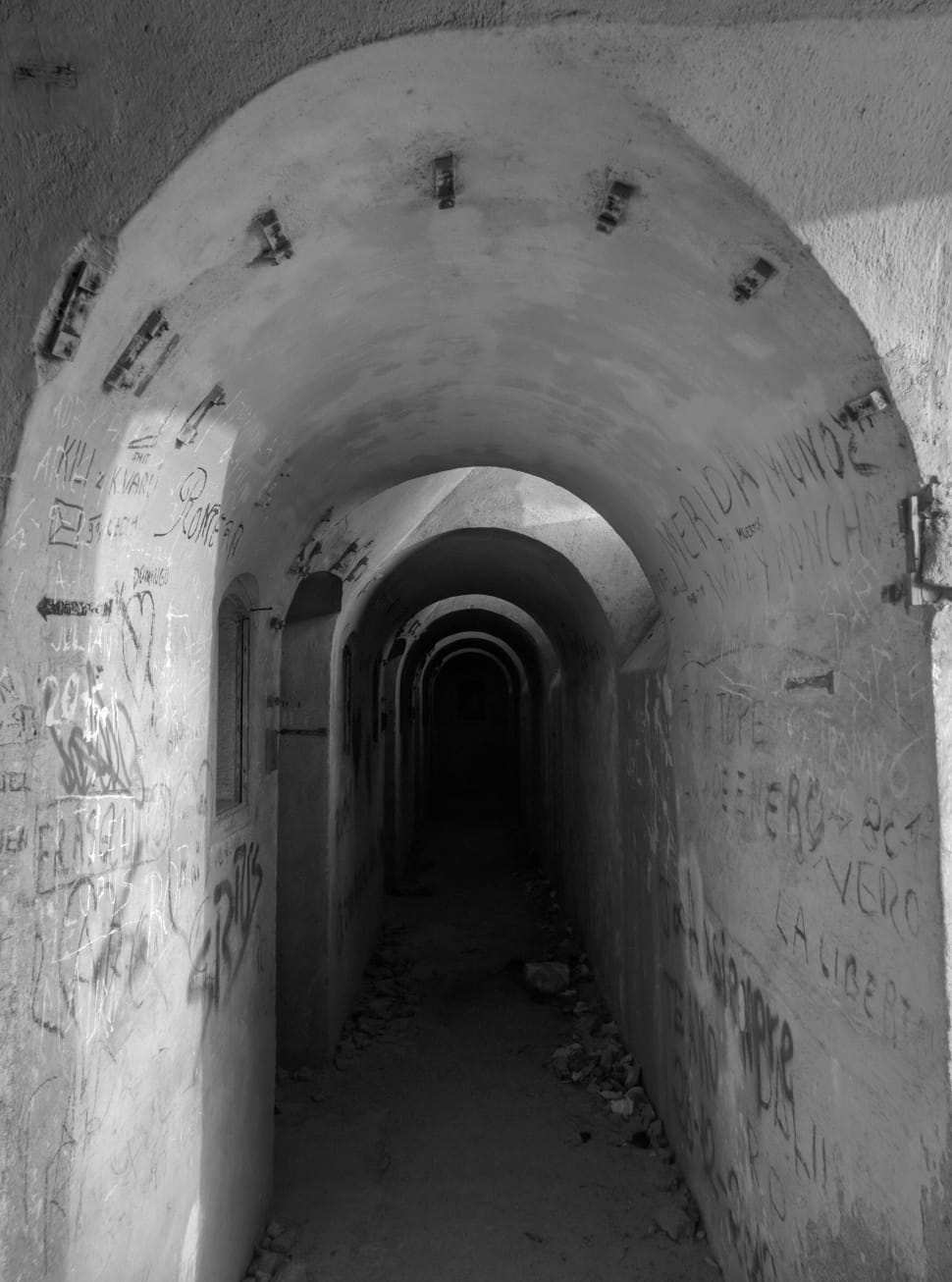 grayscale photo of conrete tunnel preview