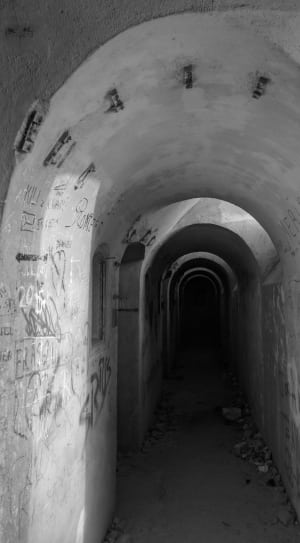 grayscale photo of conrete tunnel thumbnail