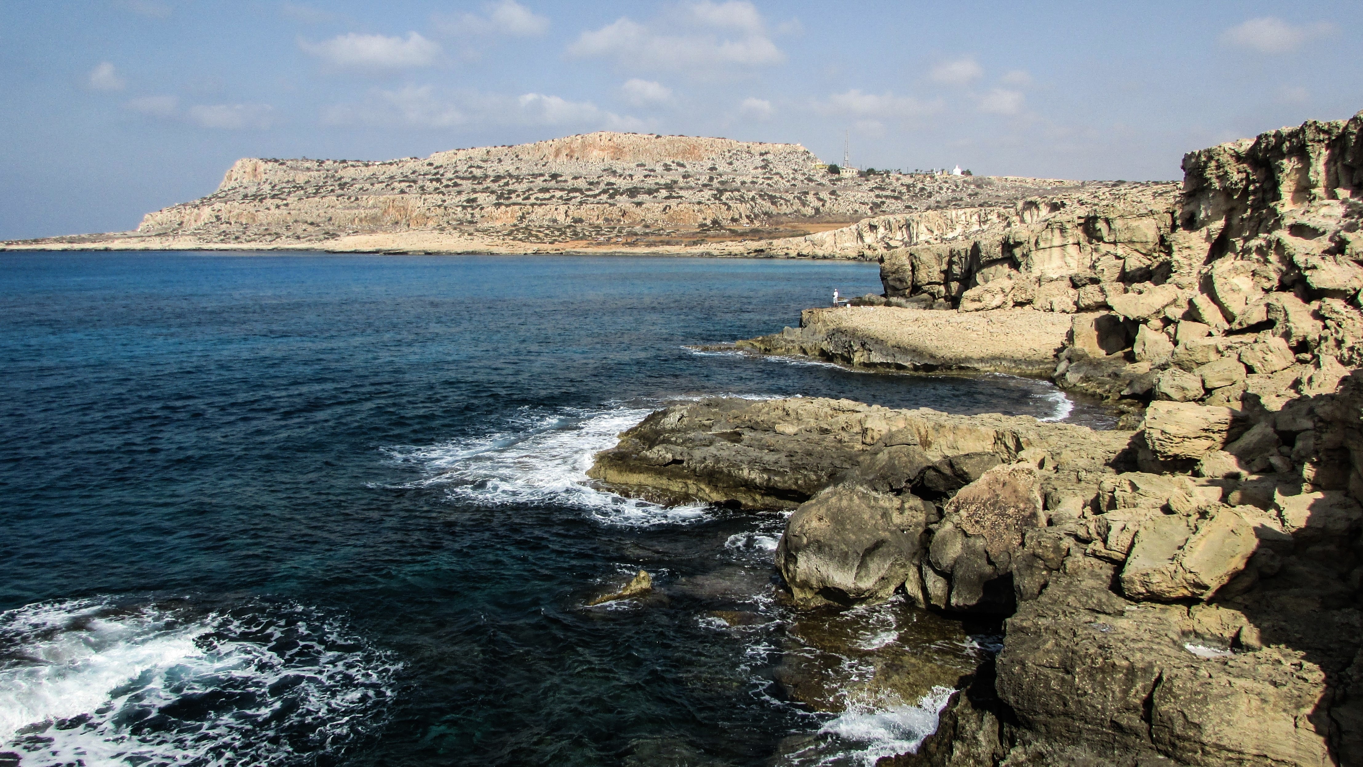 brown rocks beside the blue sea