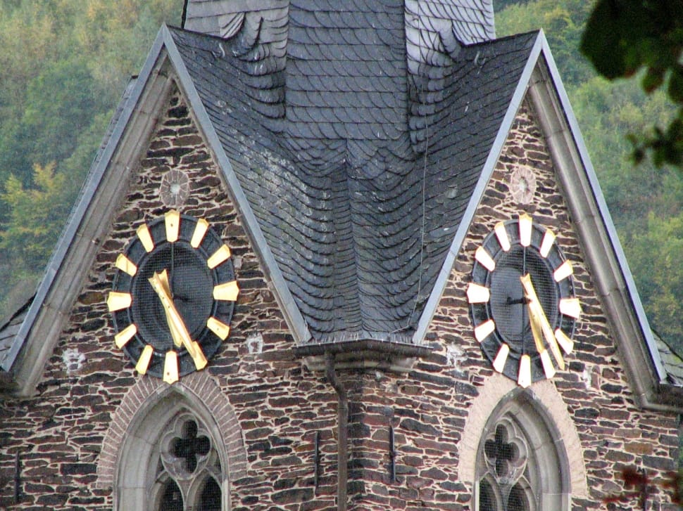 brown brick and gray roofed clock tower preview