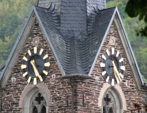 brown brick and gray roofed clock tower thumbnail