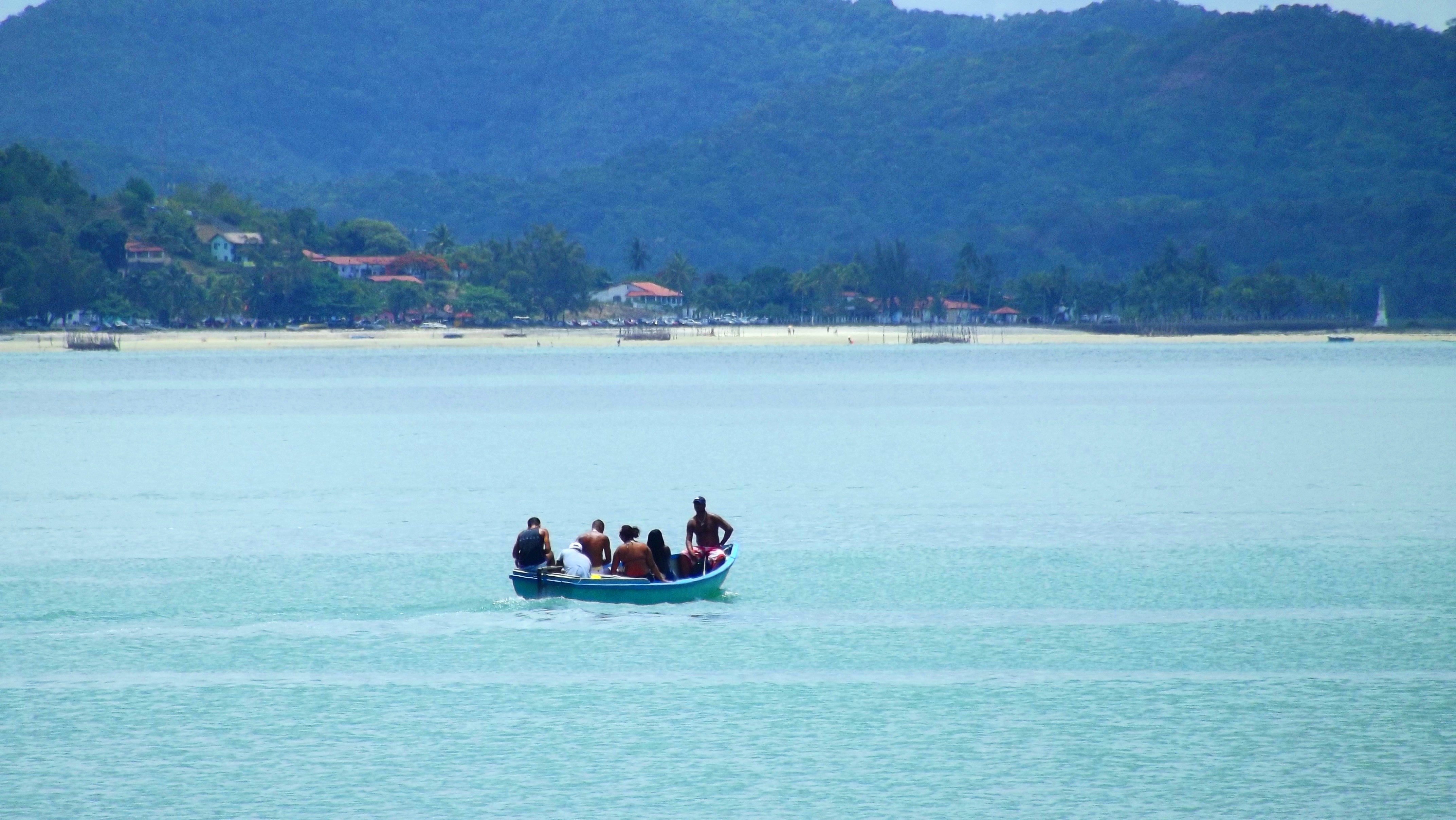 group of person on boat in body of water