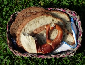 bagle and wheat bread in brown and pink wicker basket thumbnail
