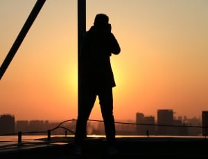 silhouette of man taking a picture to a building thumbnail