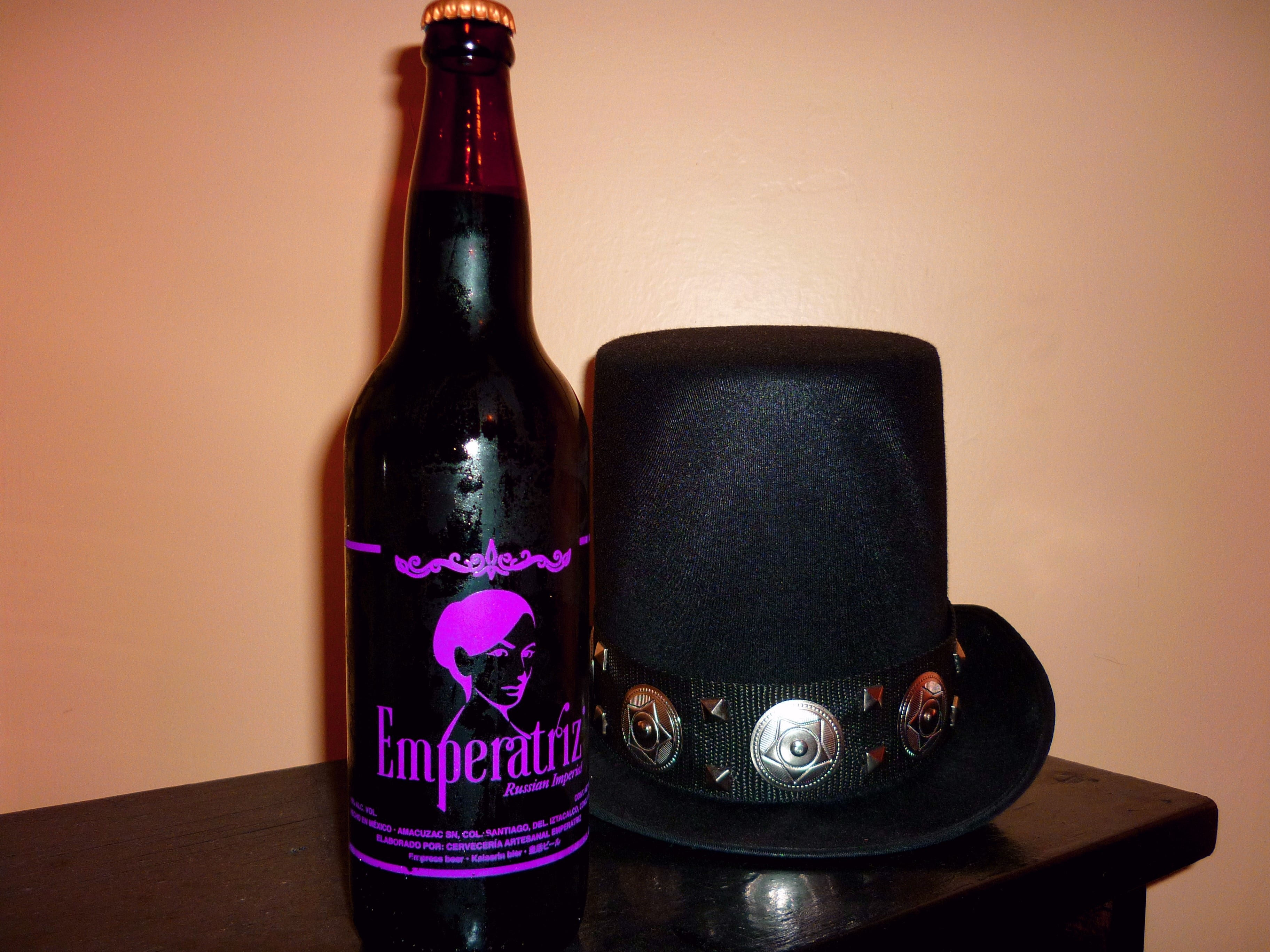 emperatriz bottle and black trilby hat