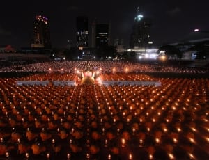 people gathering holding candle during nighttime thumbnail