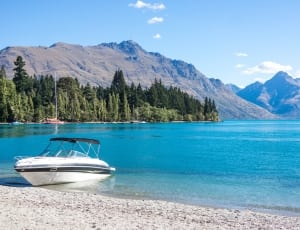 photography of white powerboat on clear body of water thumbnail