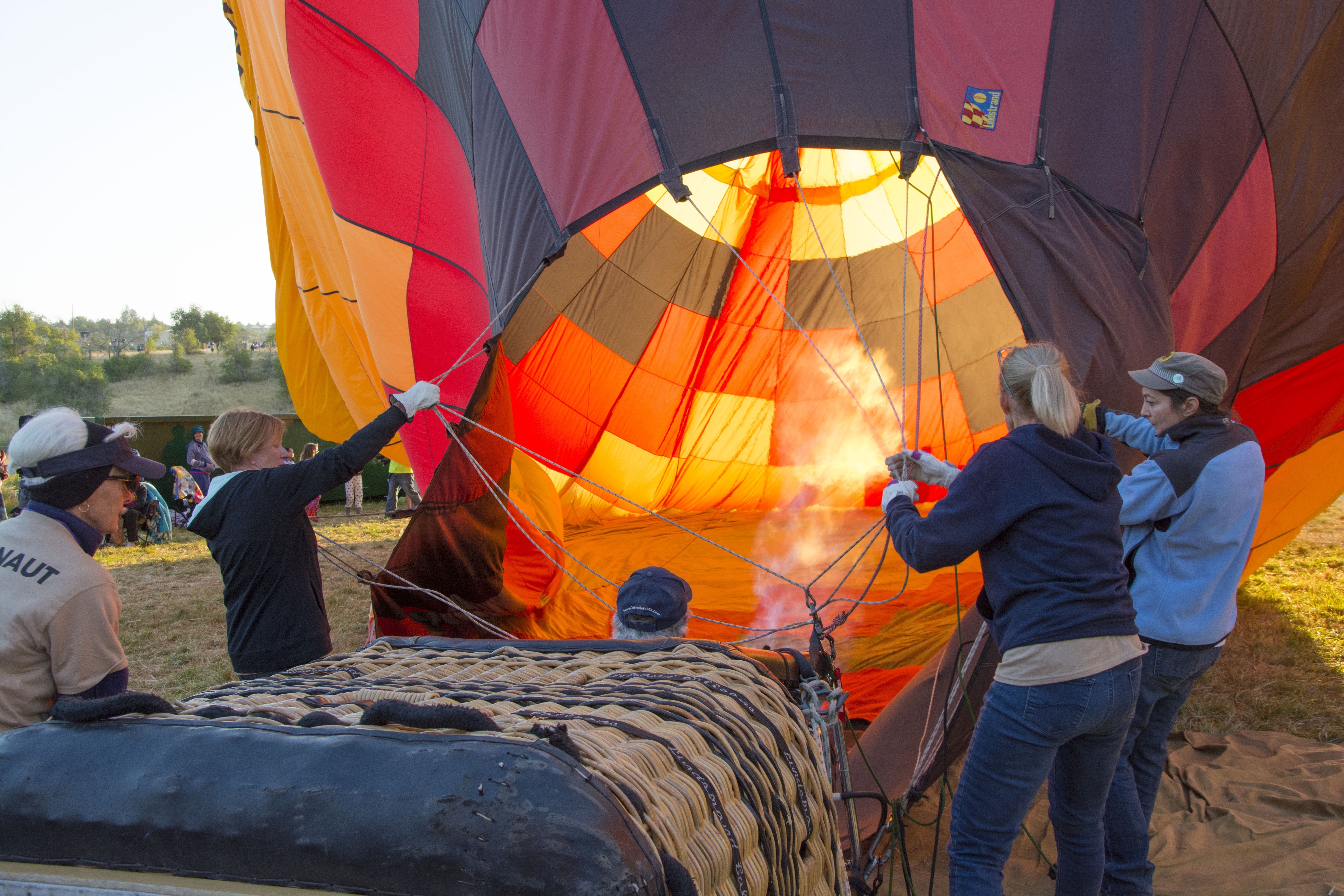 four person getting ready the hot air balloon