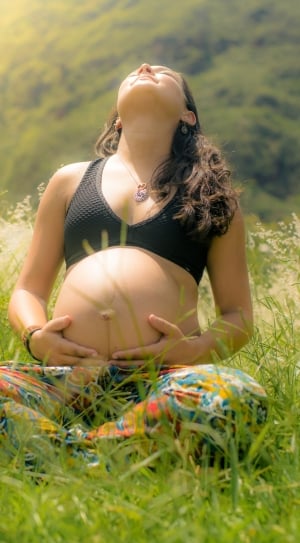 woman pregnant holding her tummy thumbnail