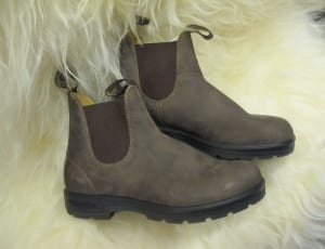 pair of leather boots on fur textile thumbnail