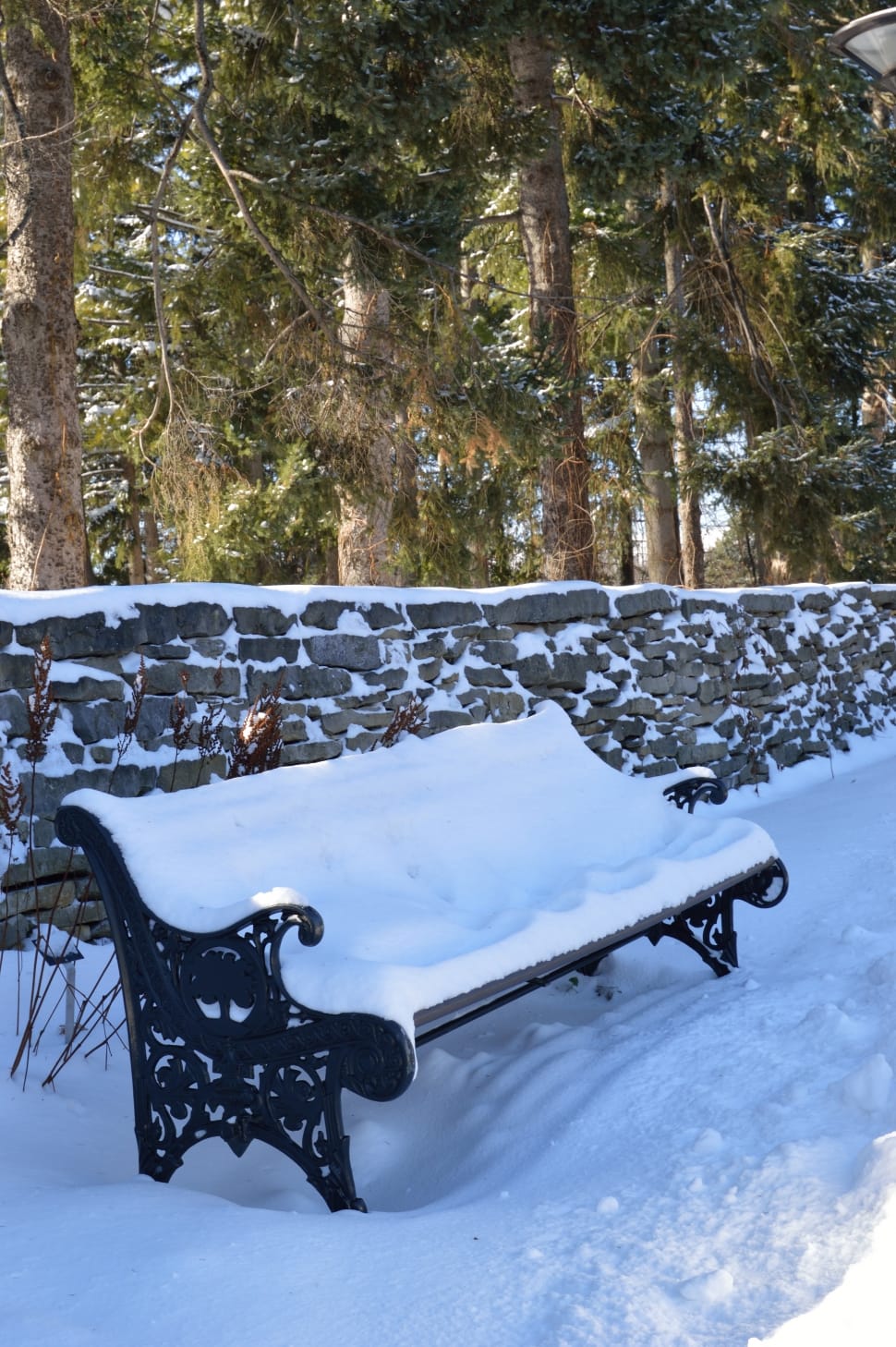 black steel outdoor bench covered with snow preview