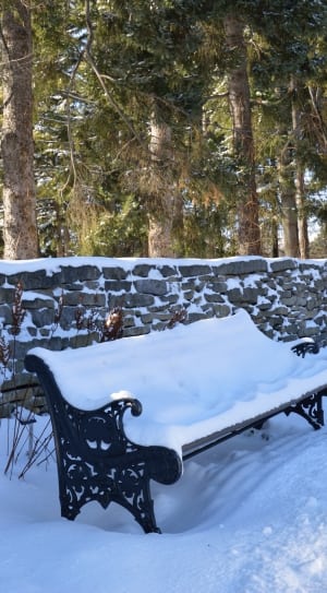 black steel outdoor bench covered with snow thumbnail