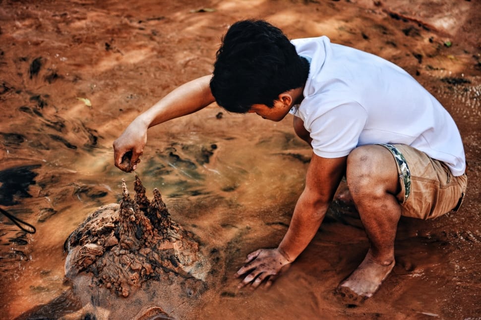 man wearing white shirt and brown pants on soil preview