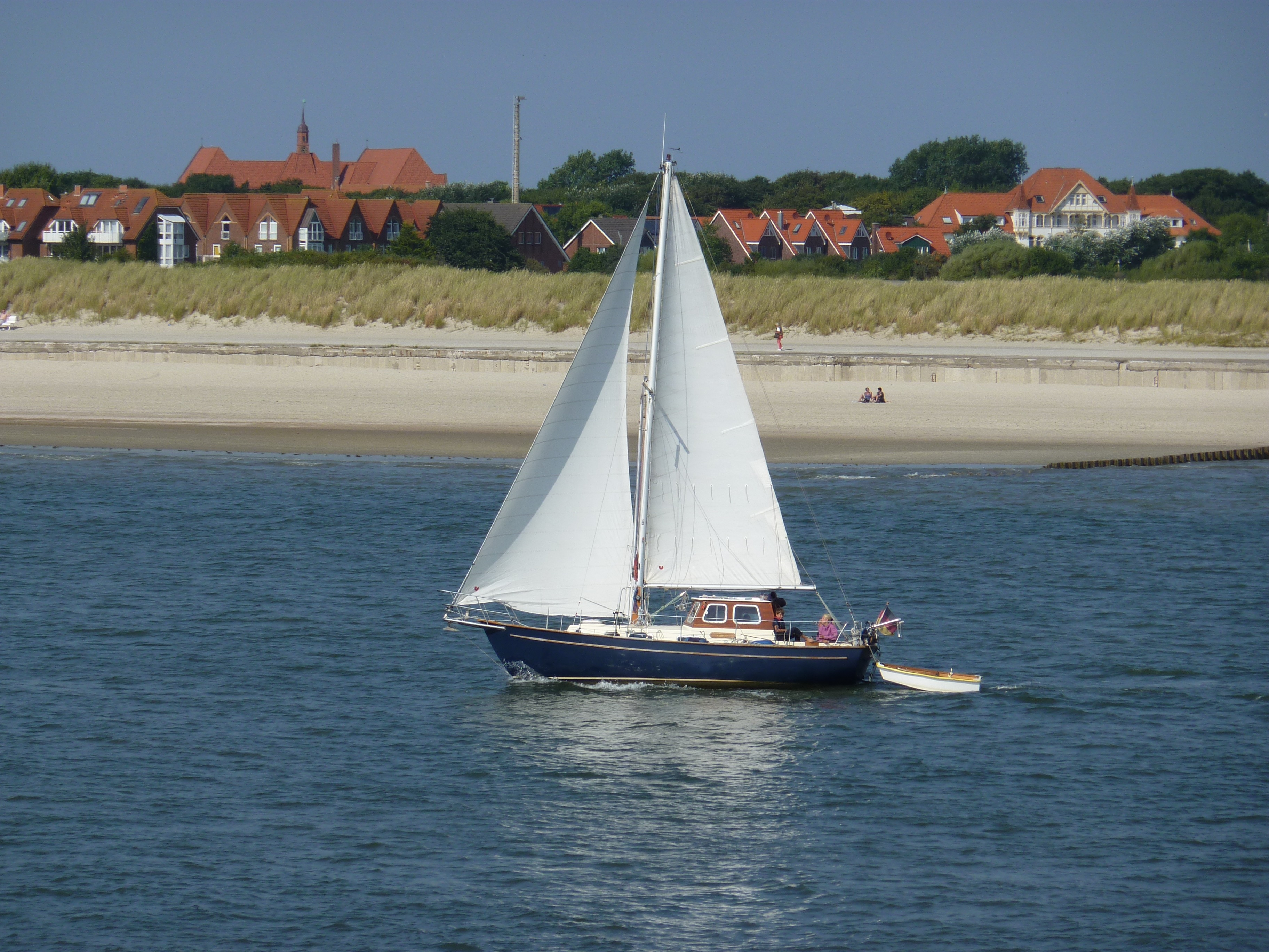 white and blue sail boat