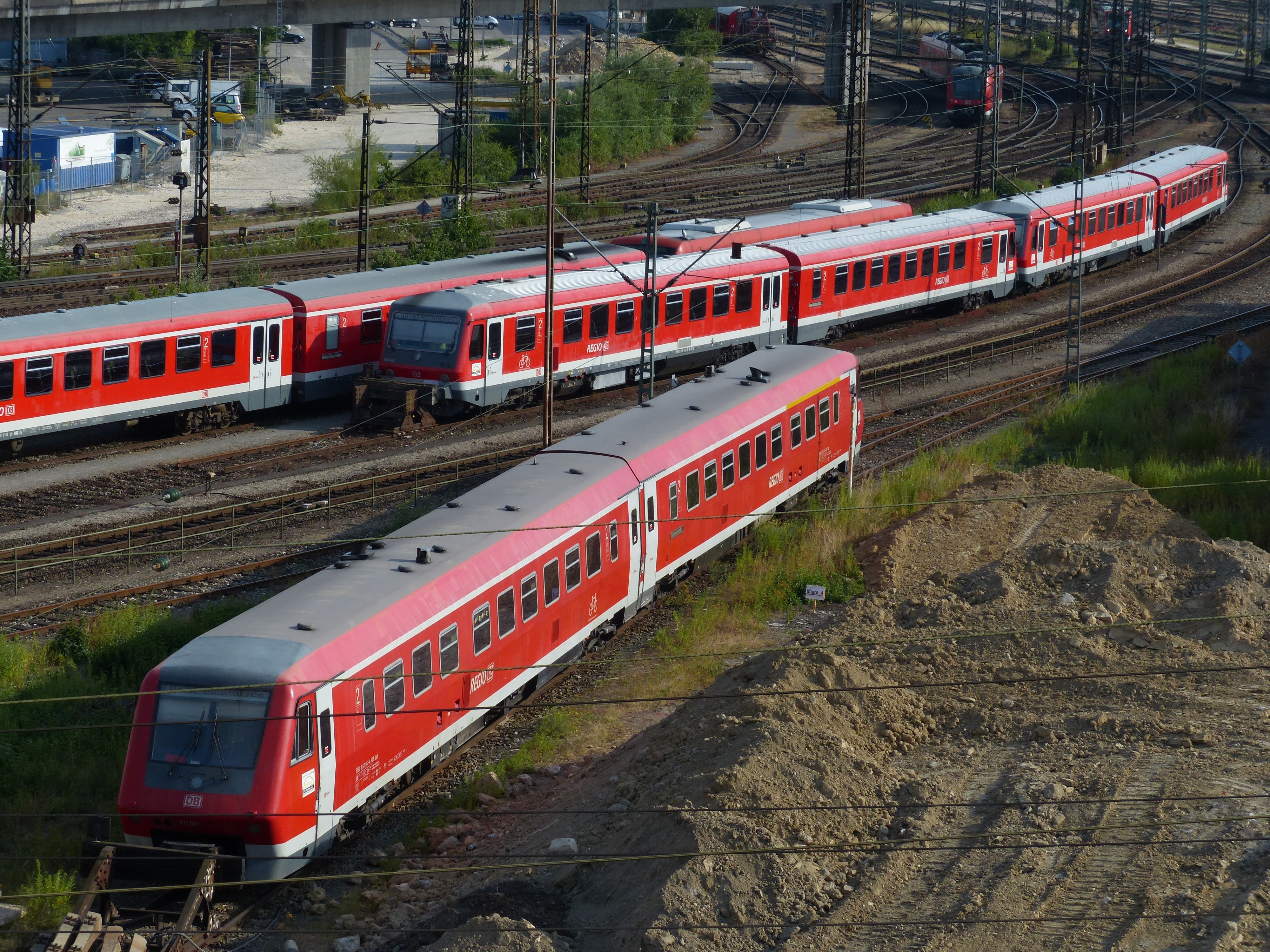3 red and silver trains