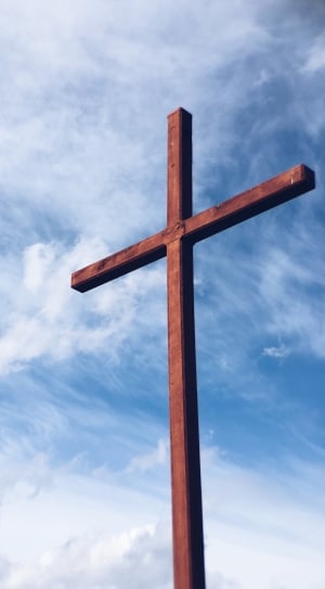 wooden cross under blue and white cloudy sky during daytime thumbnail
