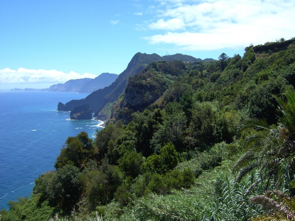 landscape photo of mountain range near body of water preview