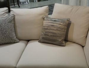 beige fabric loveseat with throw pillows thumbnail