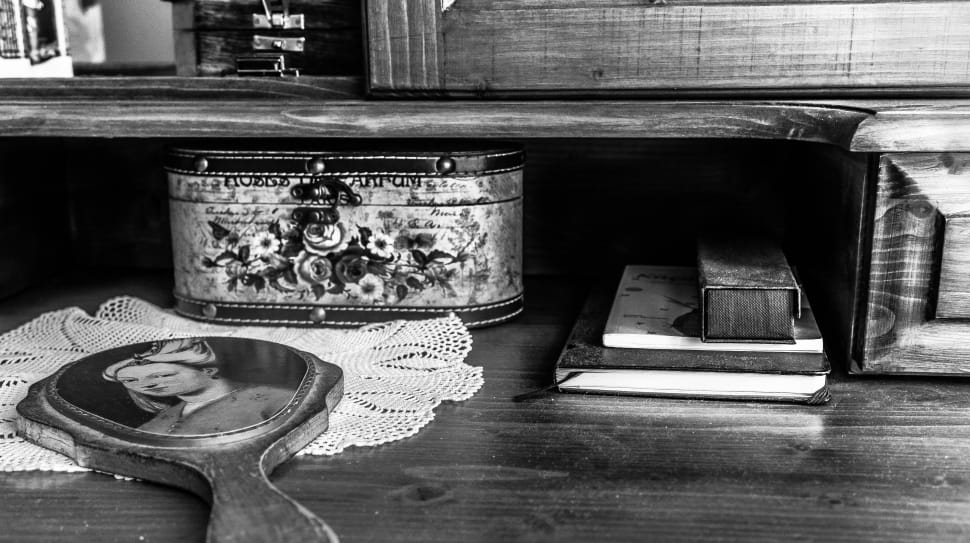 table with assorted items grayscale phot preview