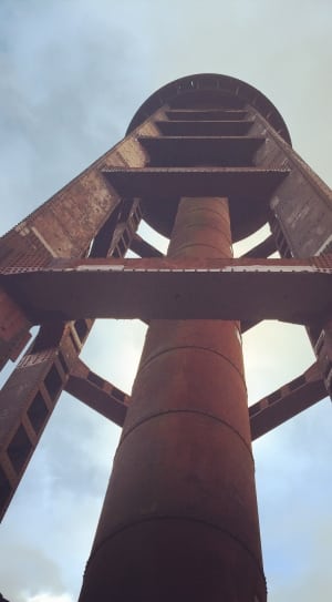 under-view photo of metal tower under nimbus clouds thumbnail