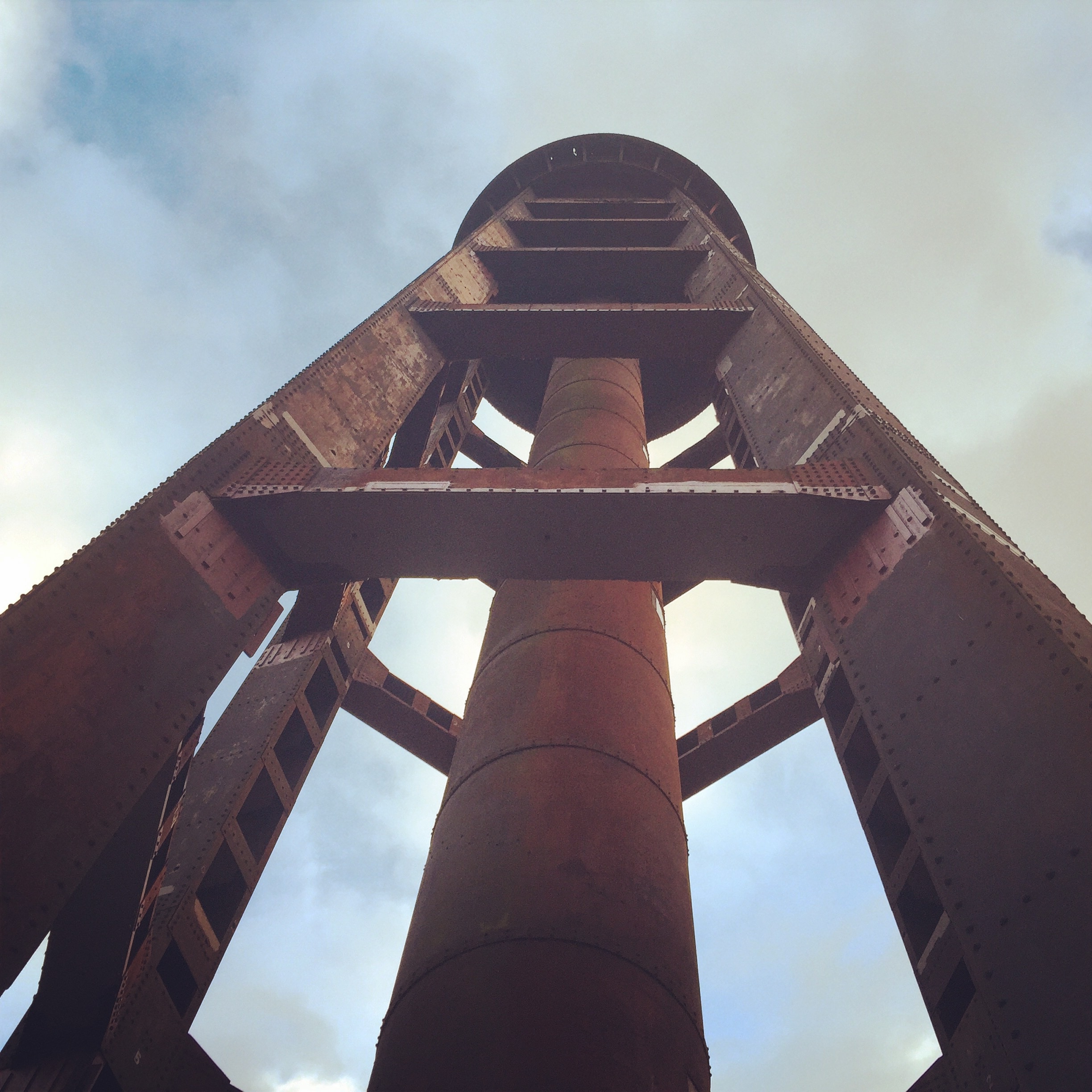 under-view photo of metal tower under nimbus clouds