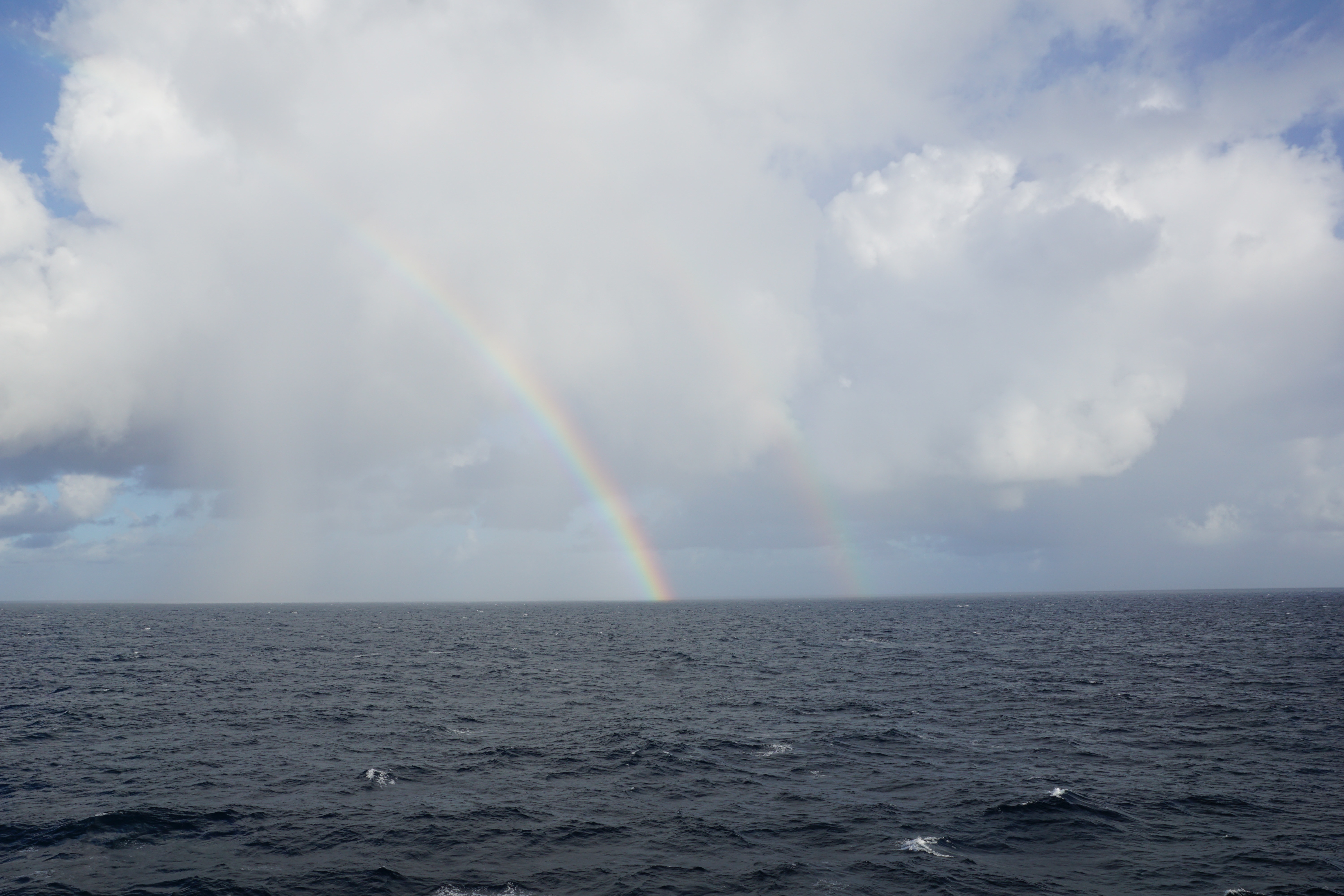 rainbow over sea water