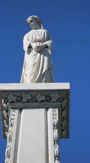 woman statue on white column during daytime thumbnail