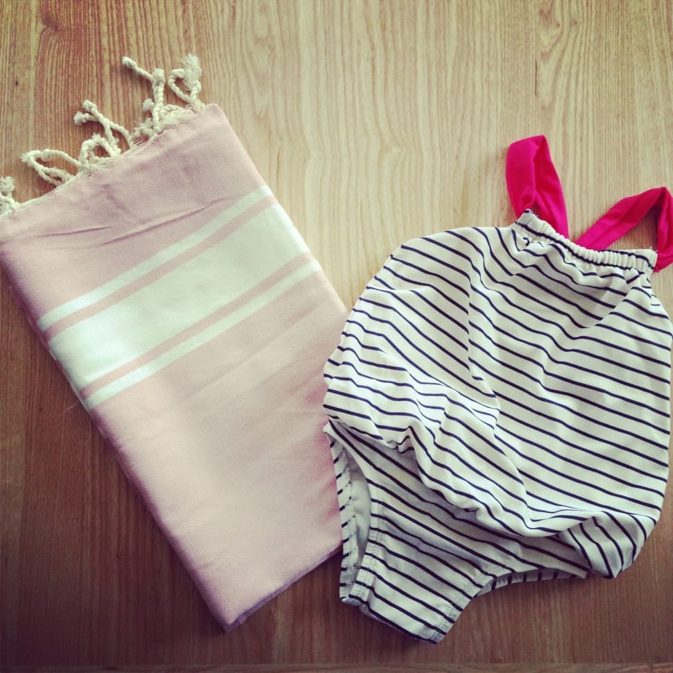 white and pink fringe scarf beside white and black stripe onesie preview