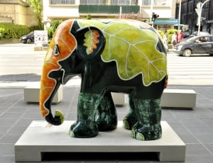 green black and orange leaf elephant ceramic figurine thumbnail