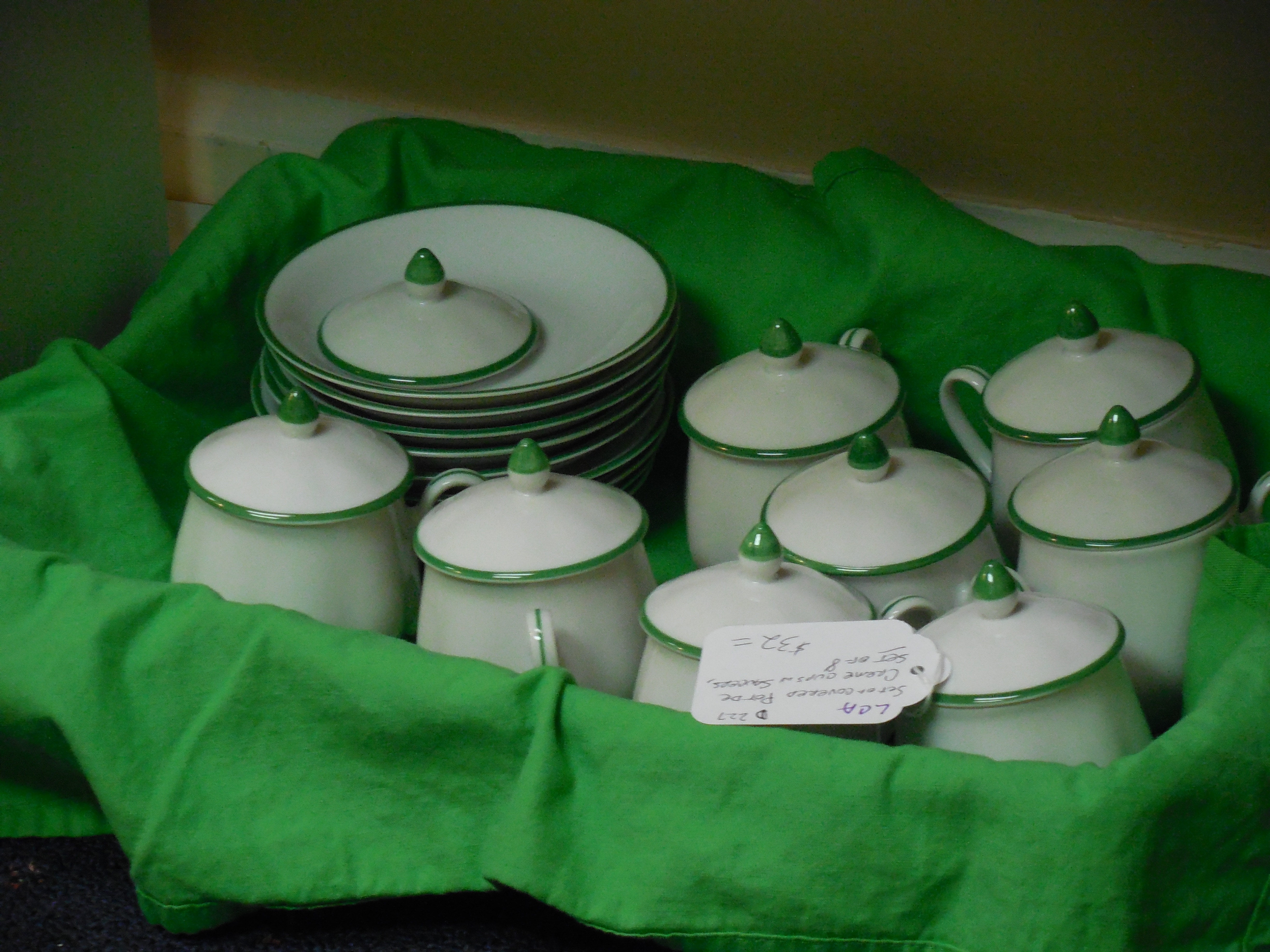 close photo of ceramic canister and saucer lot in basket