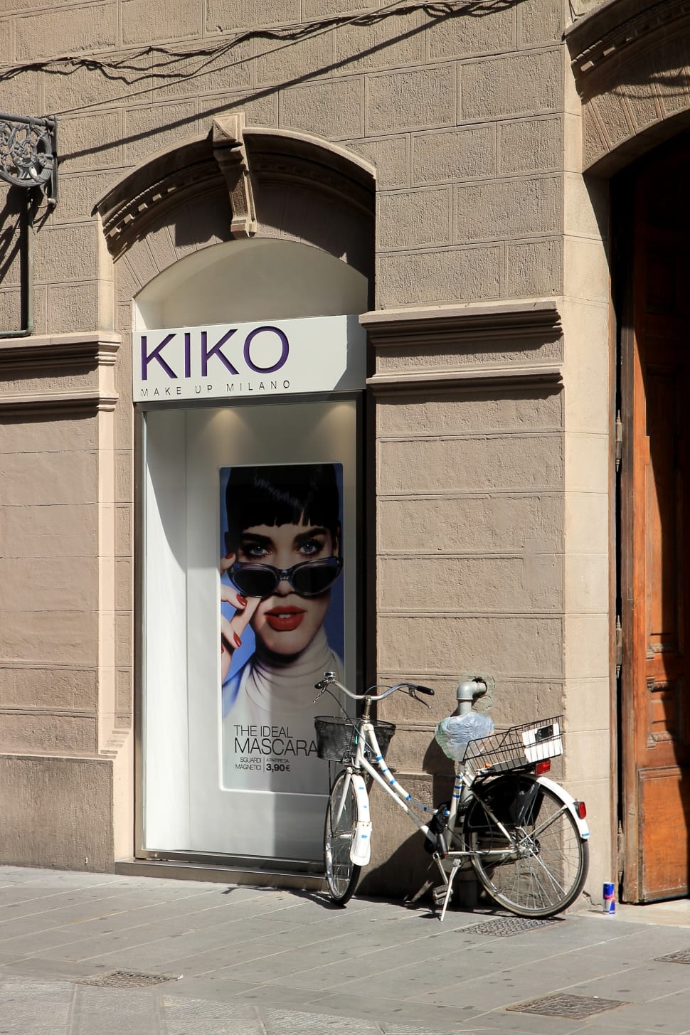KIKO signage with white cruiser bicycle parking in front preview