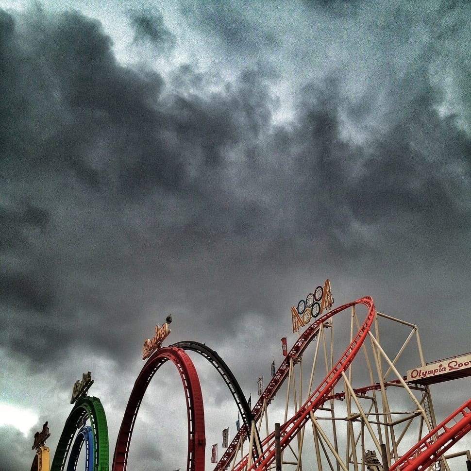 Amusement park rides under dark cloudy sky preview