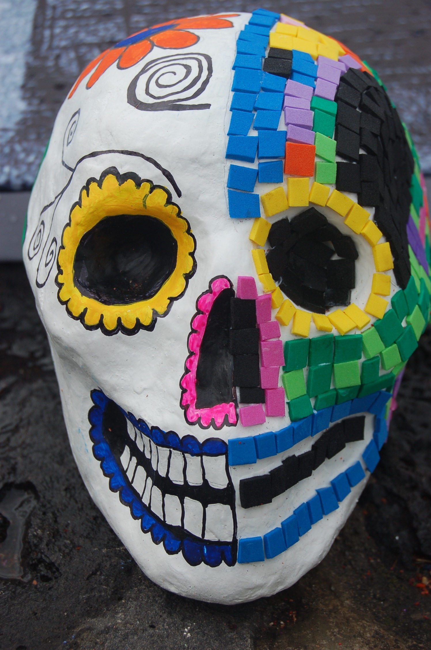 blue red yellow and multicolored day of the dead skull figurine