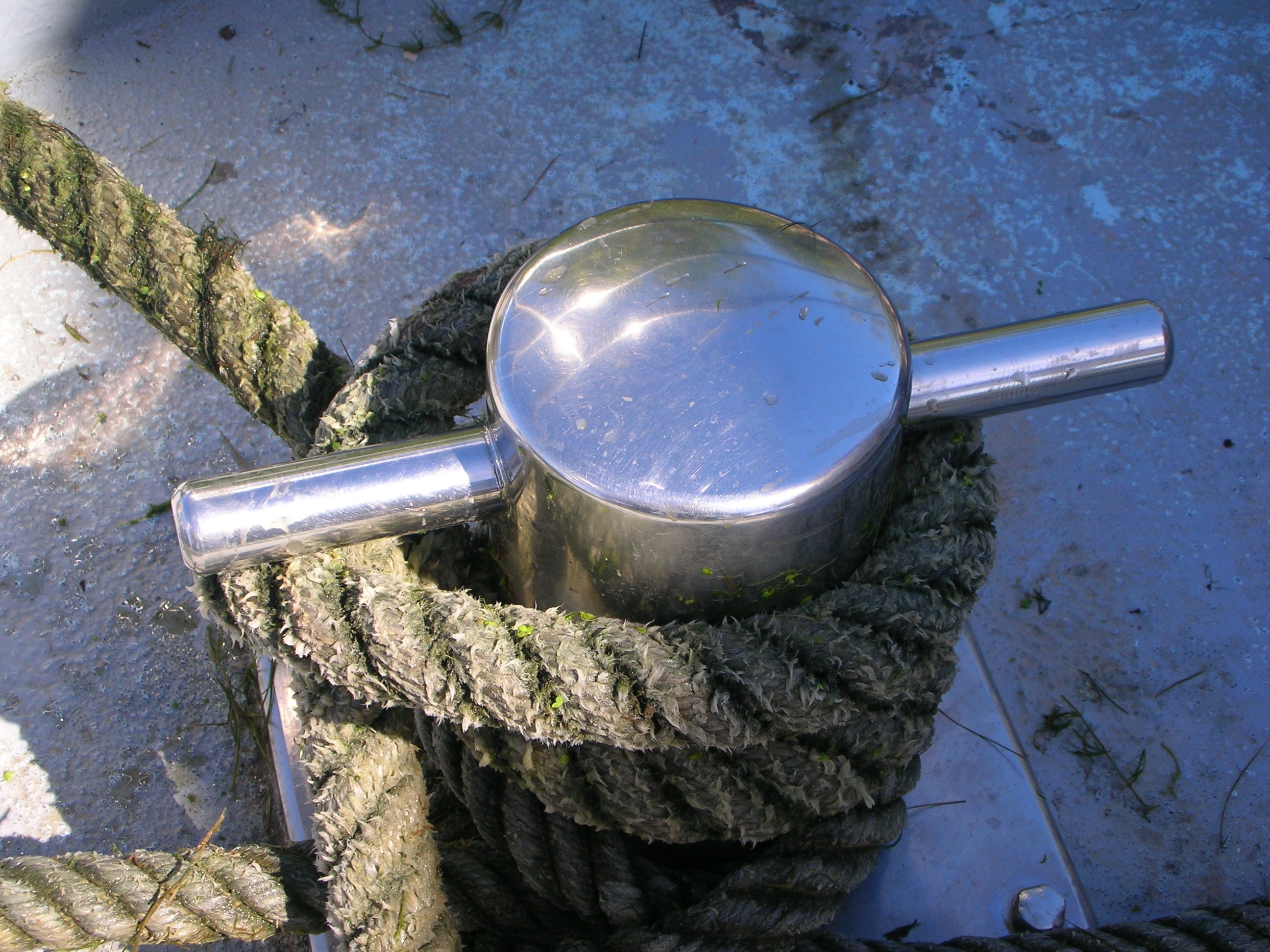 grey rope tied in stainless steel post