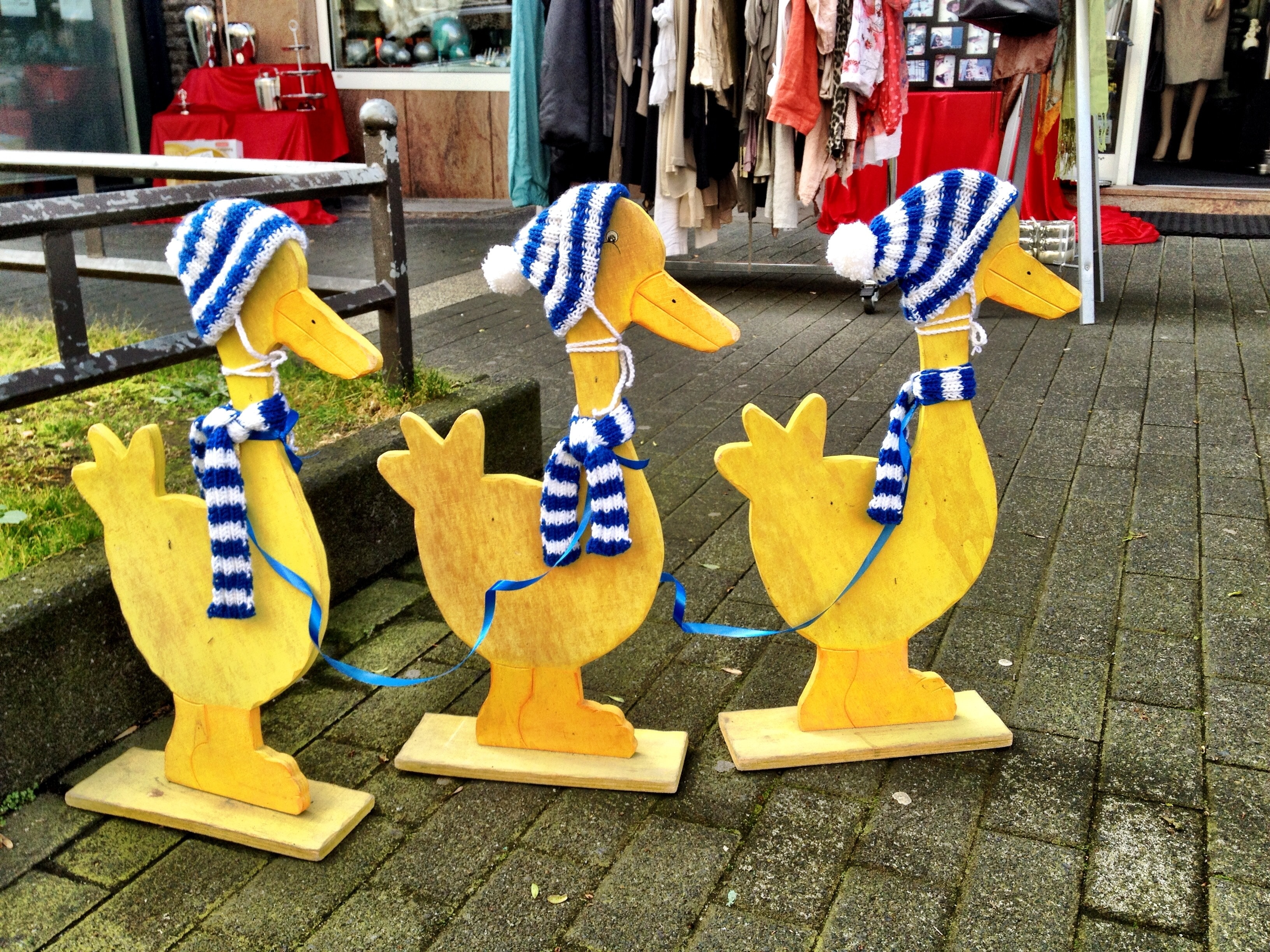 three wise brown wooden ducks standee
