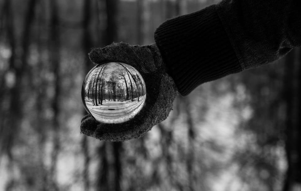 grayscale photo of a person holding a ball preview