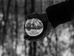 grayscale photo of a person holding a ball thumbnail
