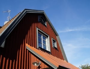 red concrete house with white wind vane thumbnail