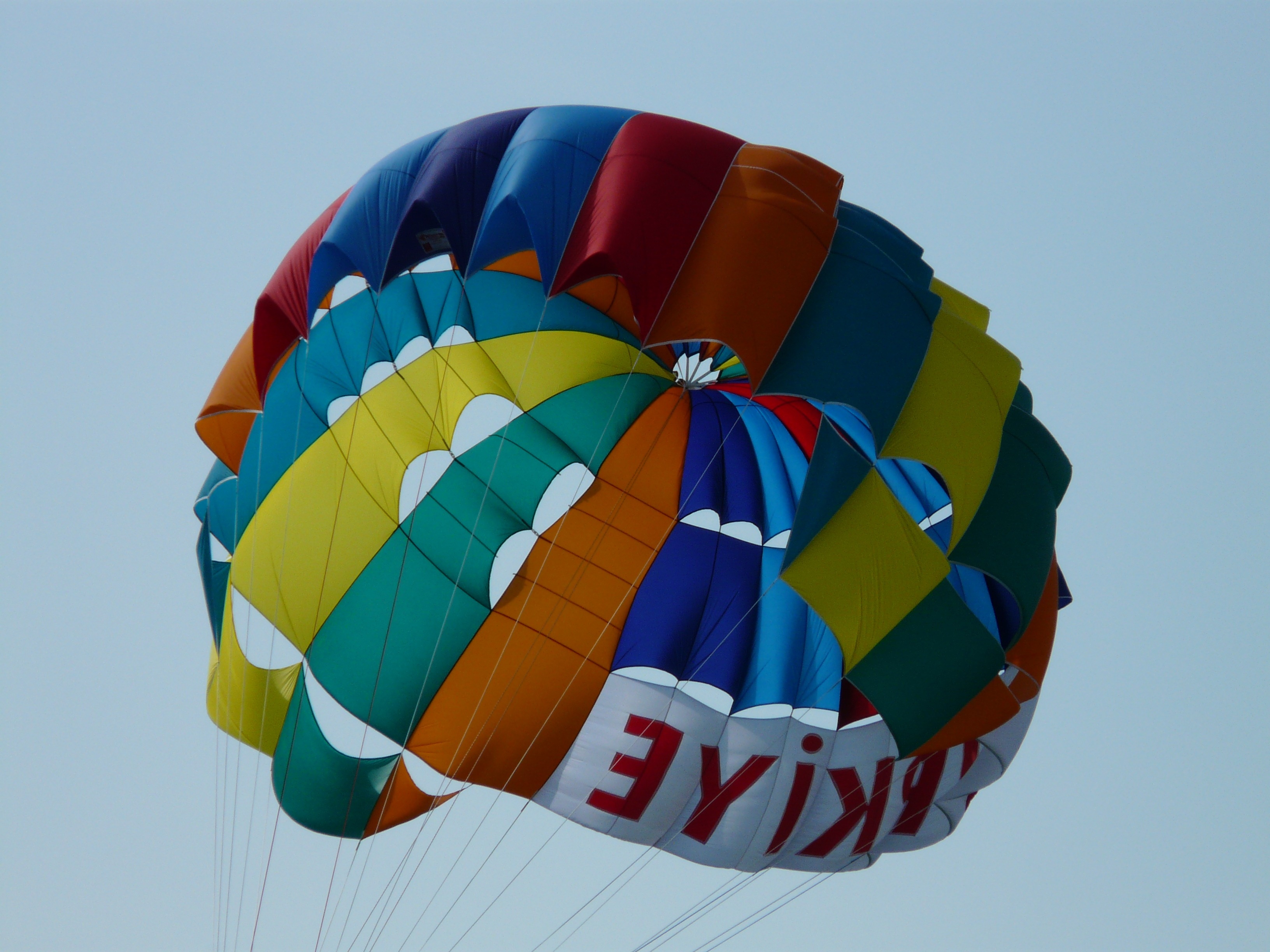 red yellow green and blue parasailing
