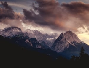 silhouette of mountain during cloudy sky thumbnail