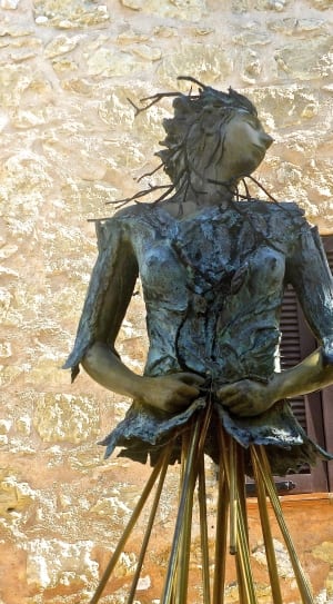 woman with branches and tree skins statue thumbnail