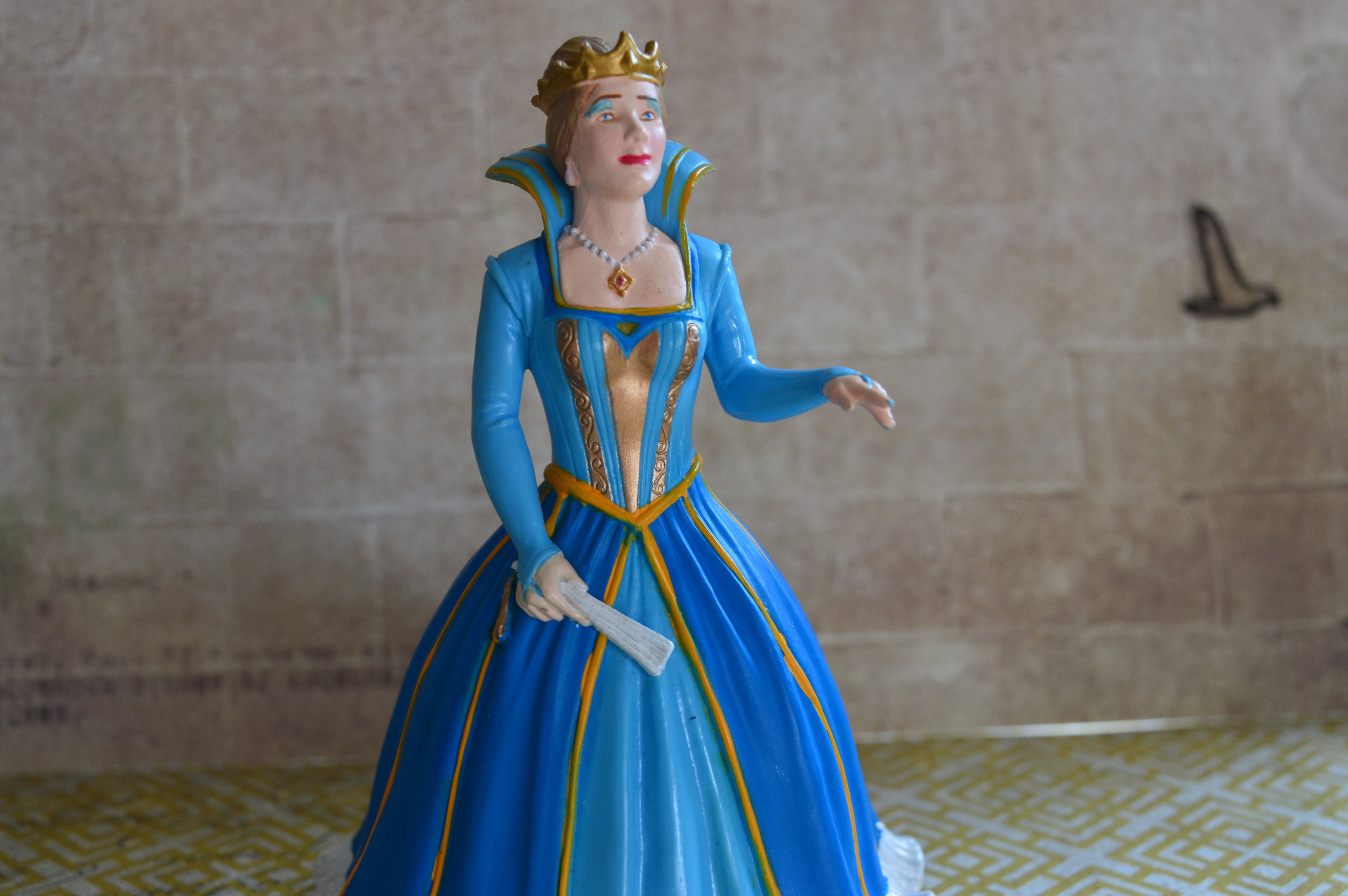 queen in blue dress figurine