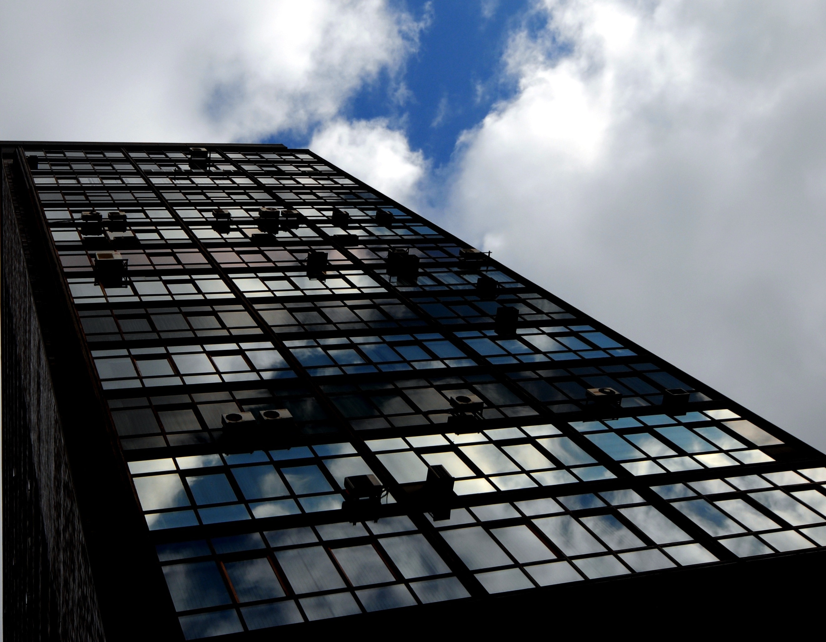 black high rise building under a cloudy sky