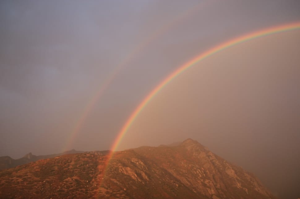 rainbow on brown mountain range preview
