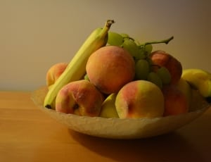 assorted fruits in white glass bowl thumbnail